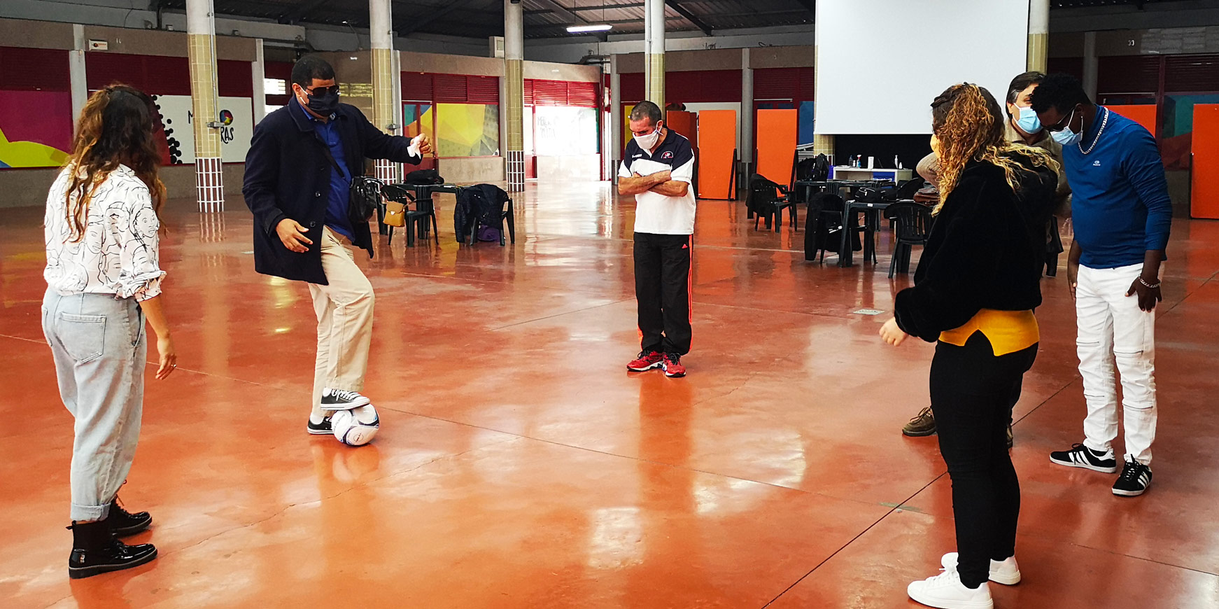 Blind participants during a workshop delivered by Integrated Dreams with participants experiencing playing blind football for the first time
