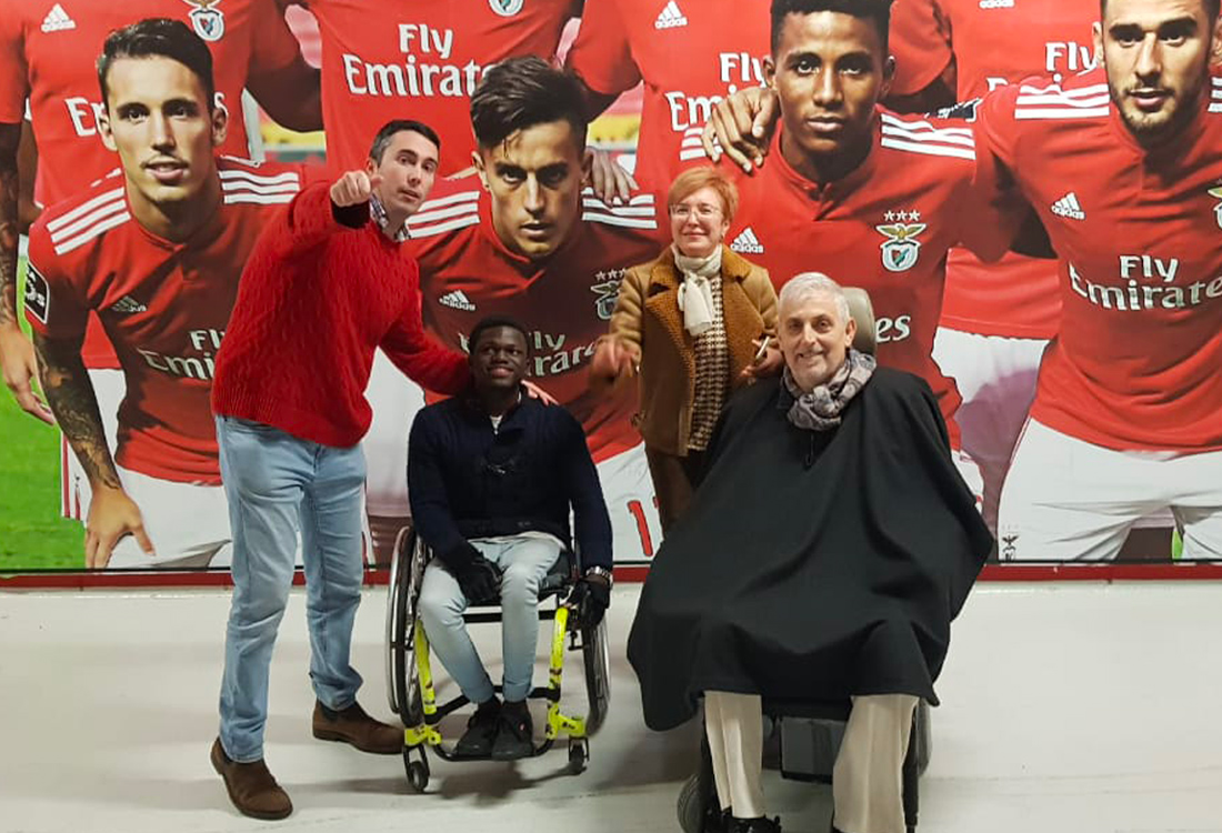 Football For All Leadership Programme participants at SL Benfica Stadium with José Soares and a background picture of Benfica players